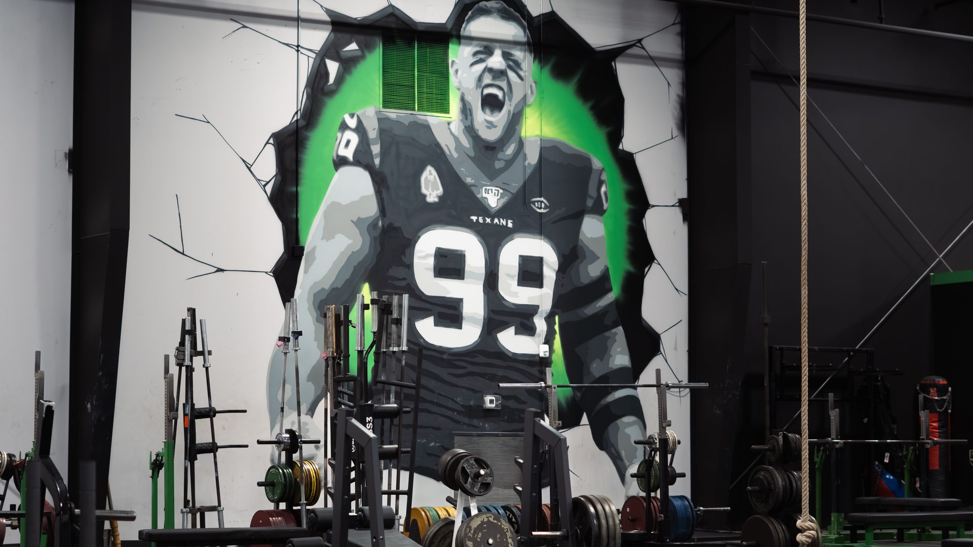 JJ Watt mural breaking through the wall at Species Gym Katy